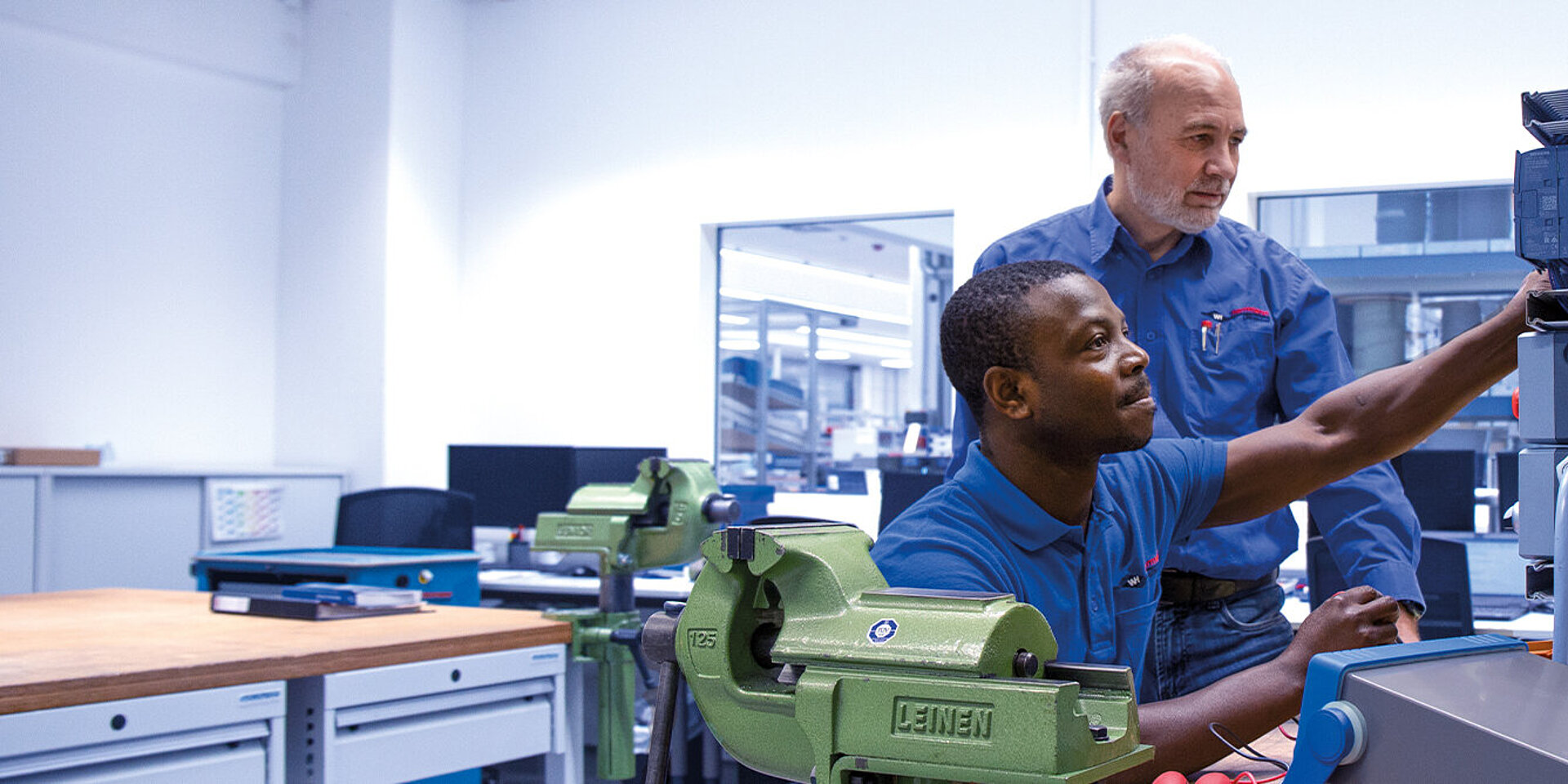 Trainees and instructors work together in the training workshop