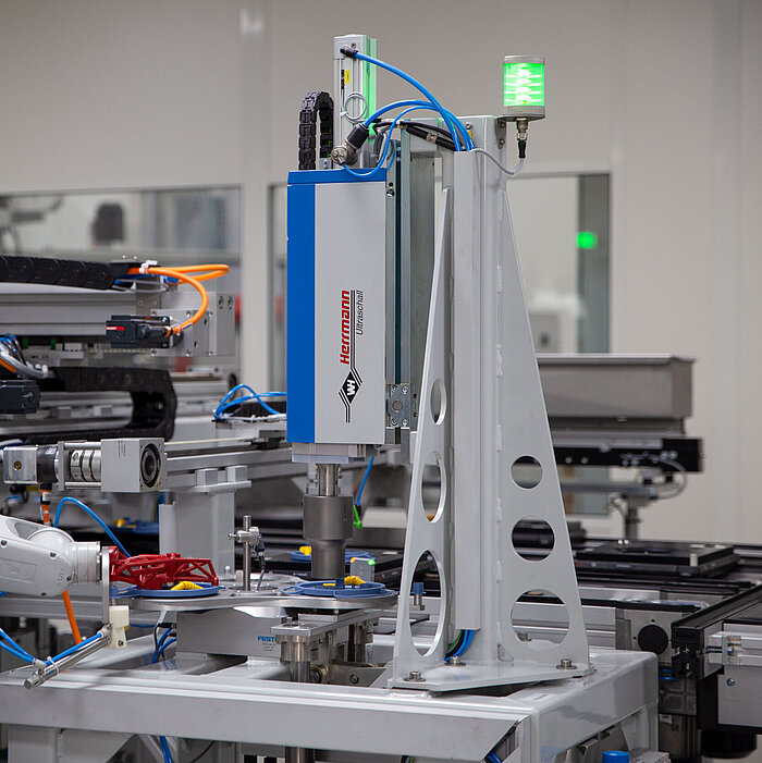 Integrated ultrasonic welding system in a manufacturing plant for medical devices