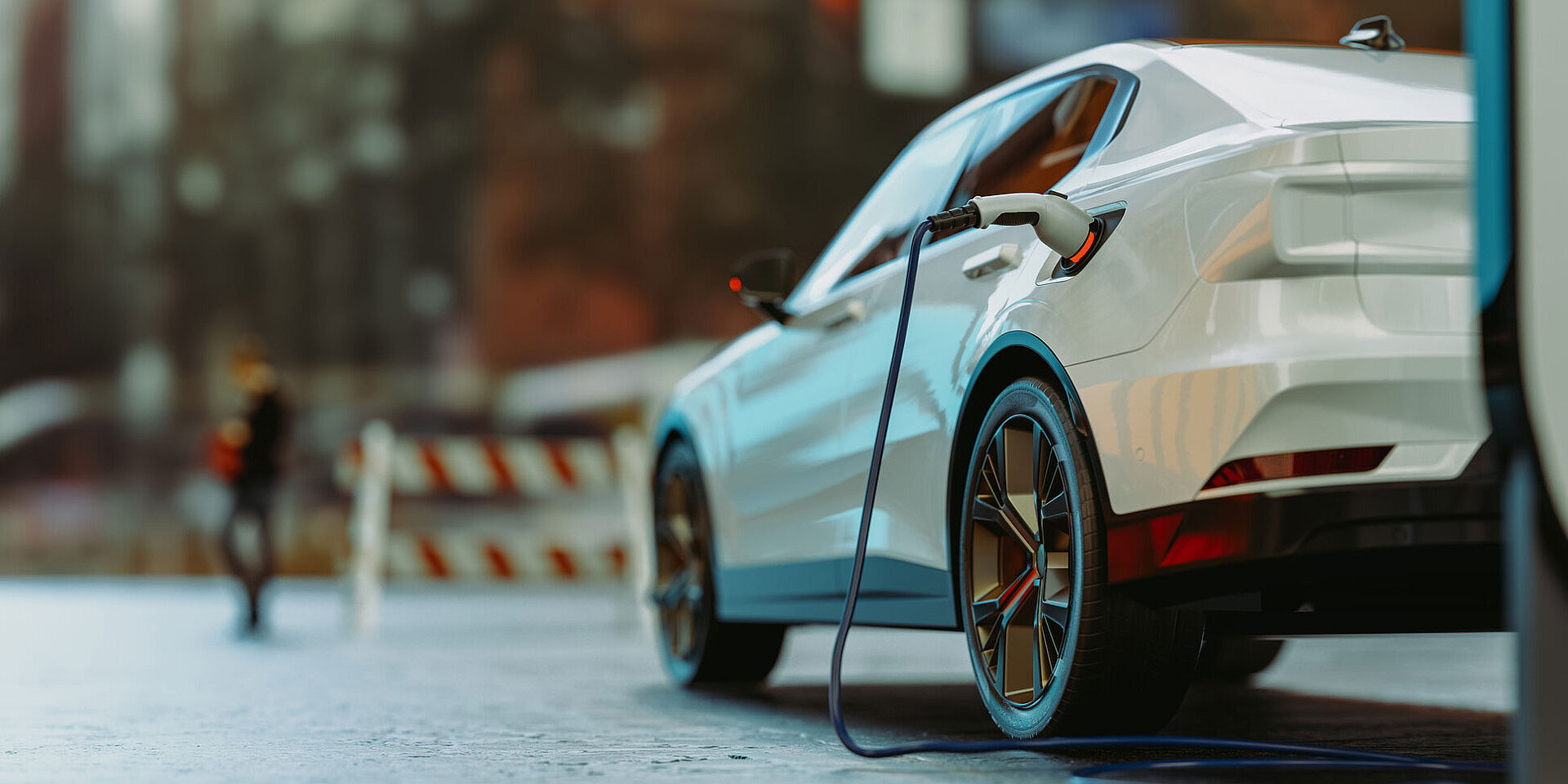 White electric car charging at a public station in the city